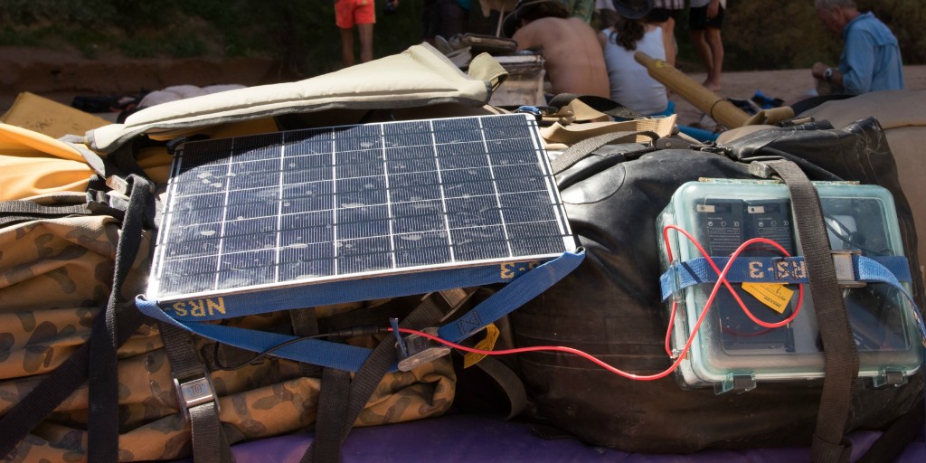closeup of 17 watt solar panel and waterproof case on raft